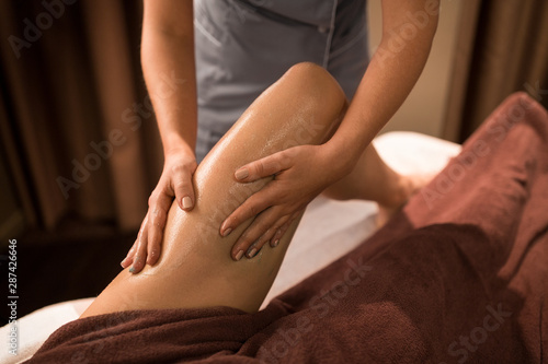 Wallpaper Mural beauty, bodycare and relaxation concept - close up of woman lying and having leg massage with gel at spa Torontodigital.ca