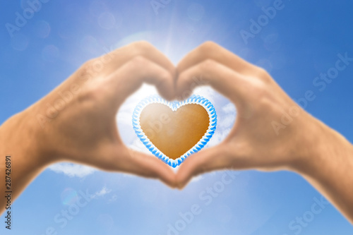 Lebkuchenherz in einer Hand in Herzform