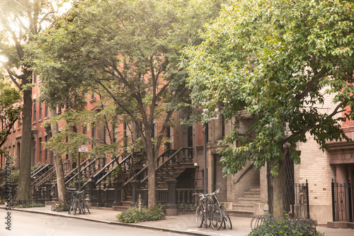 Canvas Print Summer Street scene from New York City with brownstones apartments homes and trees