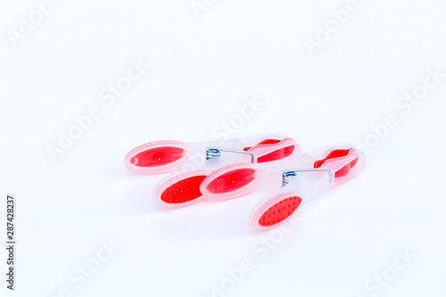 close up of clothspins in red color isolated on white background with copy space. 