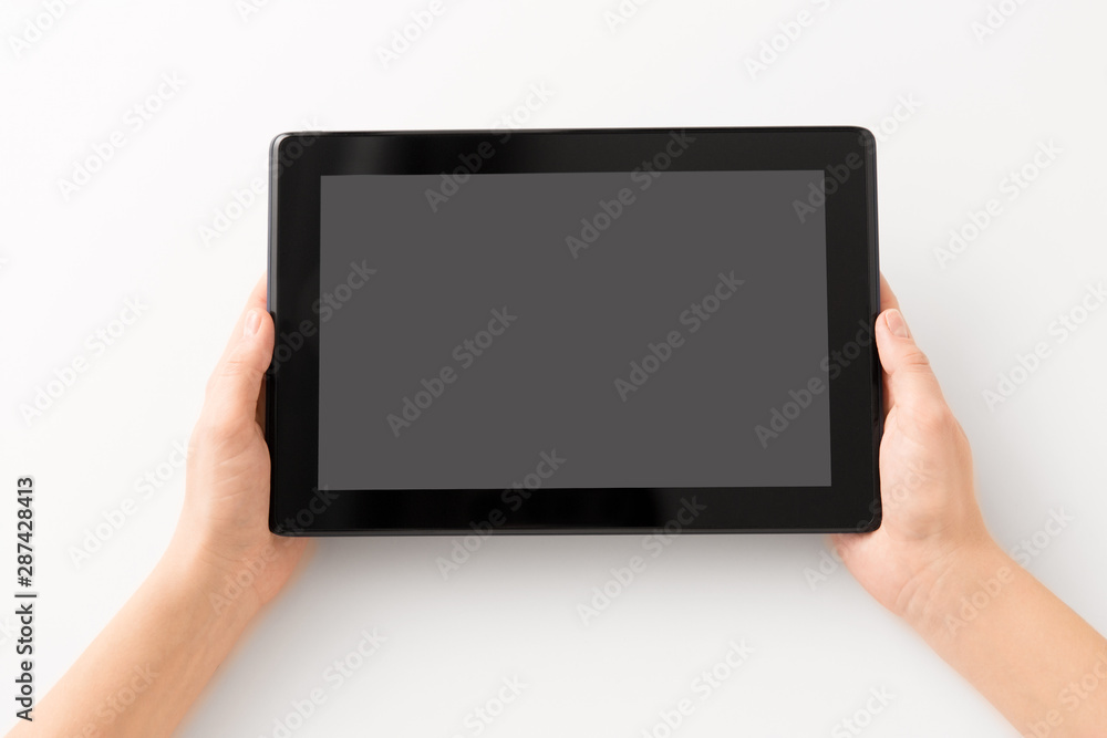 gadget and technology concept - close up of hands with black tablet computer smartphone gadget and technology concept - close up of hands with black tablet computer smartphone