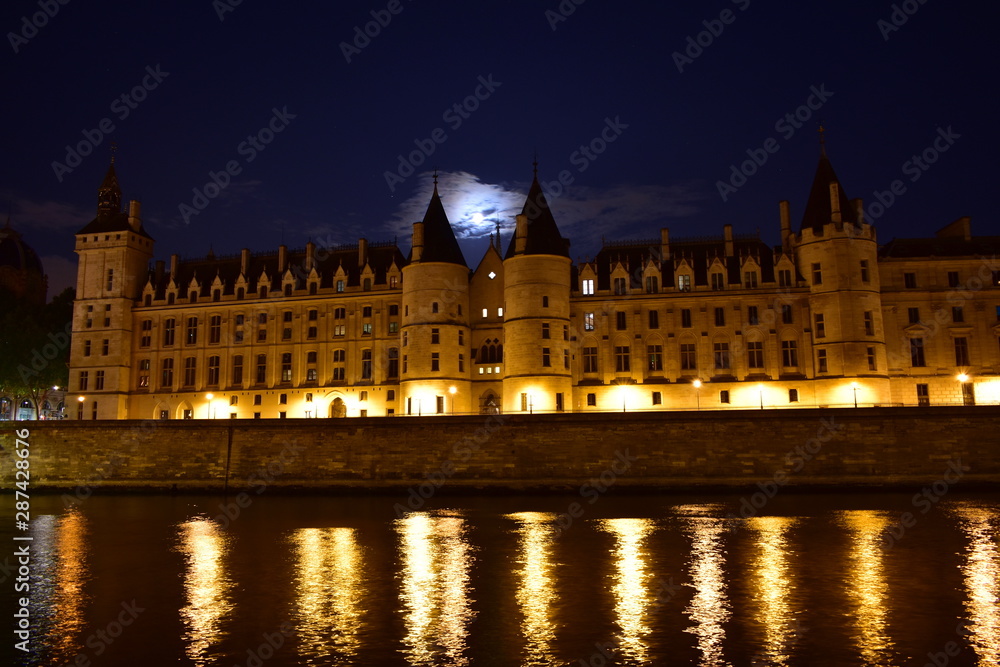 La Conciergerie from Seine River walk at night. Paris, France.
