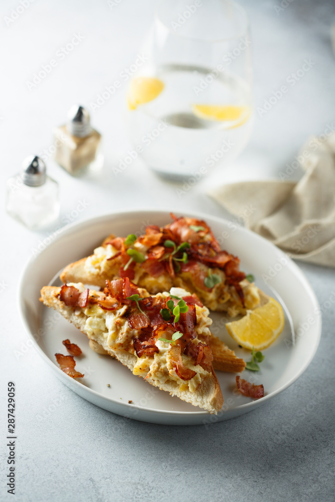 Scrambled eggs with bacon on toast Scrambled eggs with bacon on toast