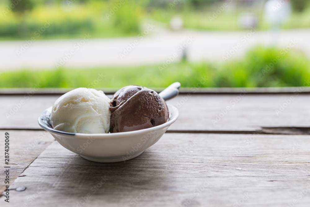 Fototapeta premium Bowl of various colorful ice cream balls on wooden background.
