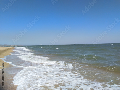 Fototapeta Naklejka Na Ścianę i Meble -  Sea waves. Sea of Crimea. High waves in clear weather. Sunny day at sea. Background blue sea waves. Sand beach. Clean beach.