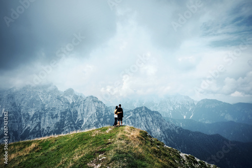 people in mountains, background alps, wonderful travel concept, space for text, atmospheric epic moment