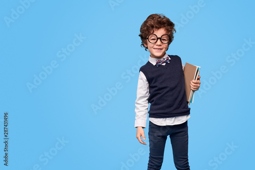 Smiling adorable wunderkind with notebooks photo