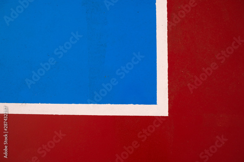 Sports ground colorful red and blue graphic pattern with white corner touchlines. photo