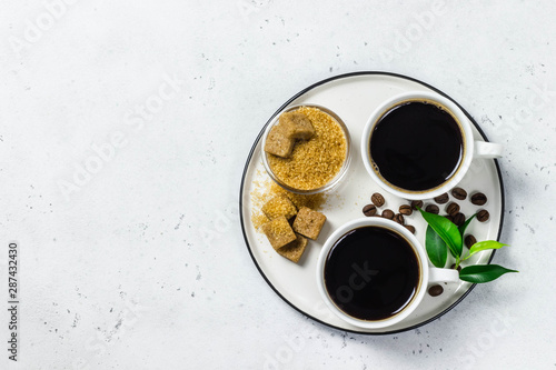 Black coffee in white cups on concrete background. Top view  space for text.