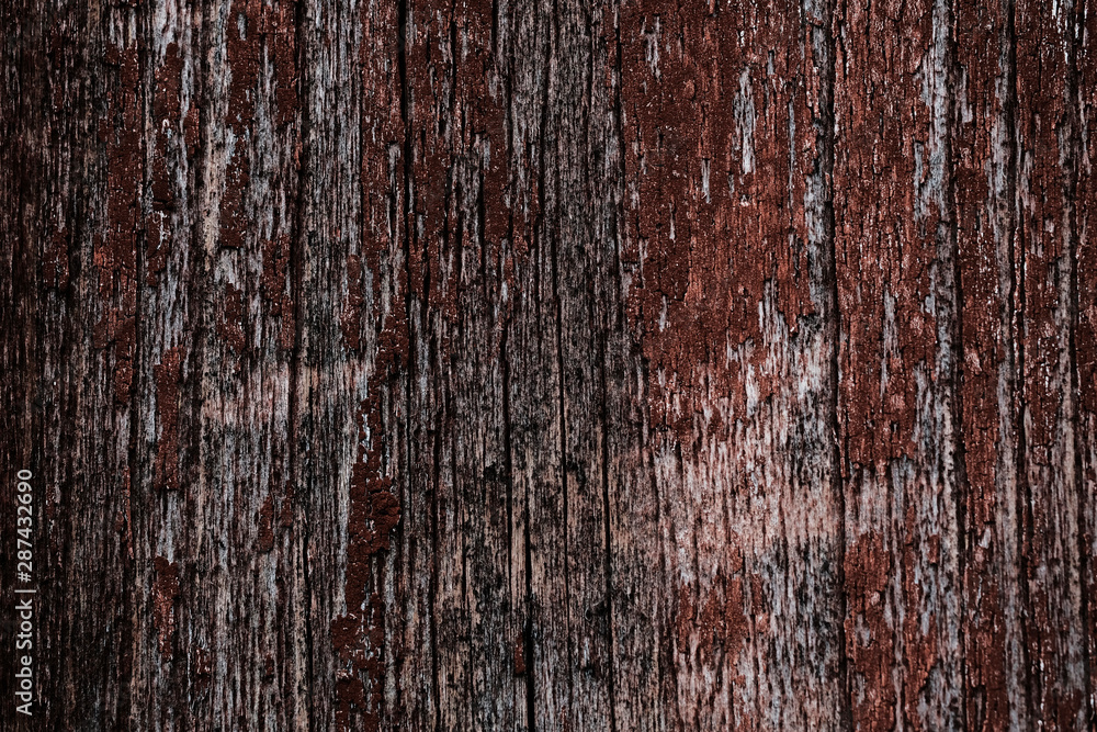 Old peeling paint on a wooden surface. background of retro wall painted in red paint