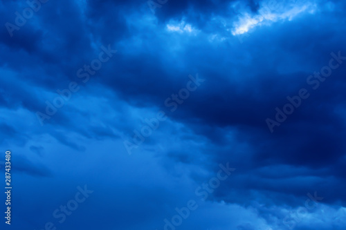 Blue hour sky clouds background. Beautiful landscape with stormy clouds and purple sun on sky © PhotoGranary