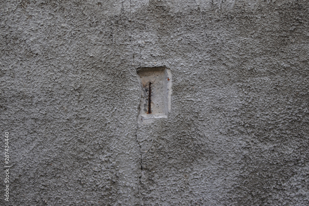 The texture of the concrete wall with a hole in the middle. The texture of the concrete wall with a hole in the middle.