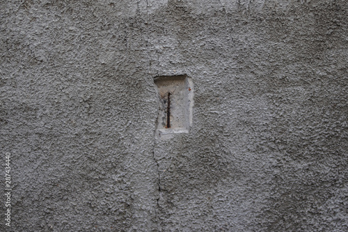 The texture of the concrete wall with a hole in the middle. © Vladimir