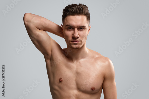 Handsome shirtless man showing muscle