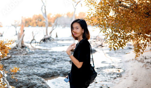 Asian woman at Coast with Orange Autumn leaf