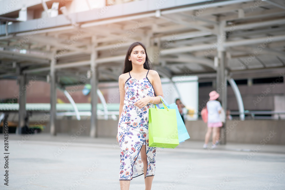 Beautiful woman is happy with shopping in city Beautiful woman is happy with shopping in city