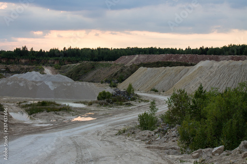 An old abandoned limestone quarry in Russia at sunset on a summer evening