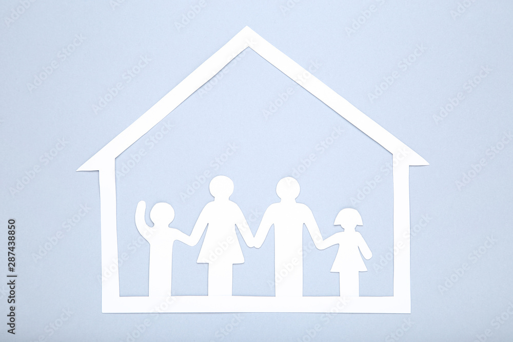 Paper family figures and house on grey background Paper family figures and house on grey background