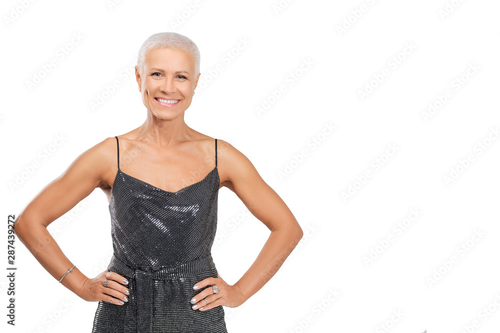 Portrait of smiling middle-aged woman in cocktail dress with hands on waist Portrait of smiling middle-aged woman in cocktail dress with hands on waist