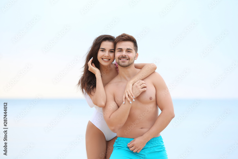 Happy young couple spending time together on beach Happy young couple spending time together on beach