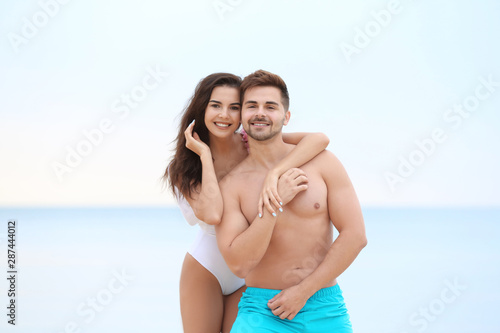 Happy young couple spending time together on beach