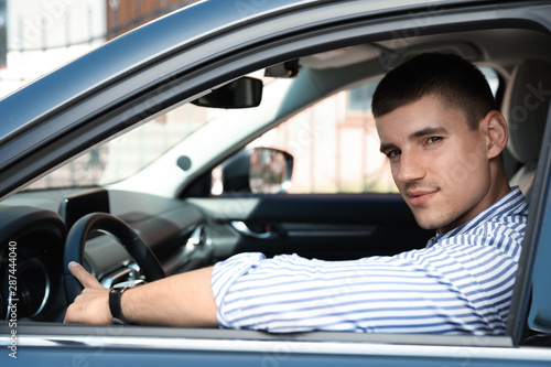 Attractive young man in modern luxury car © New Africa