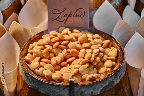 Close-Up Of Lupini Beans In Wooden Barrel photo