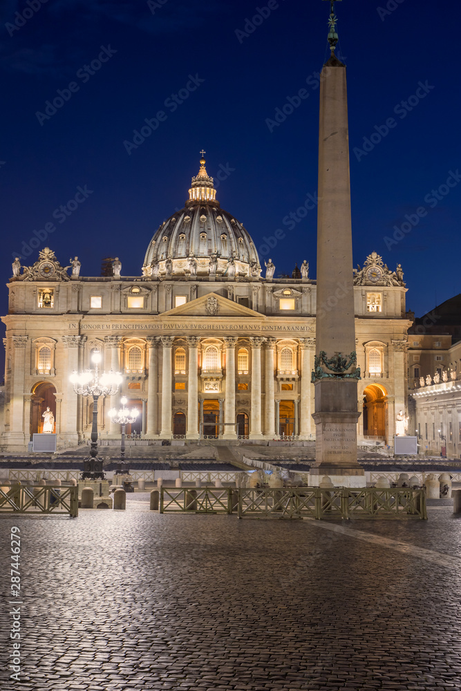 St. Peter's Square and St. Peter's Basilica  in Vatican City at night. Vertically.  