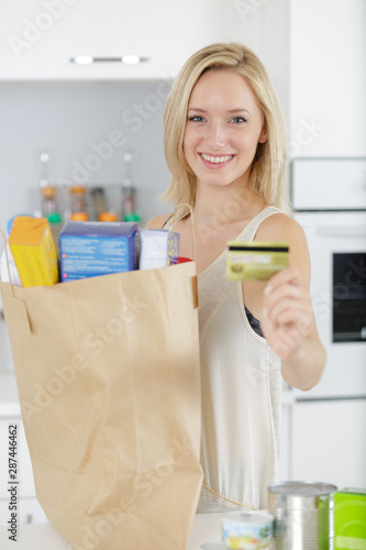 happy woman holding shopping bags and credit card