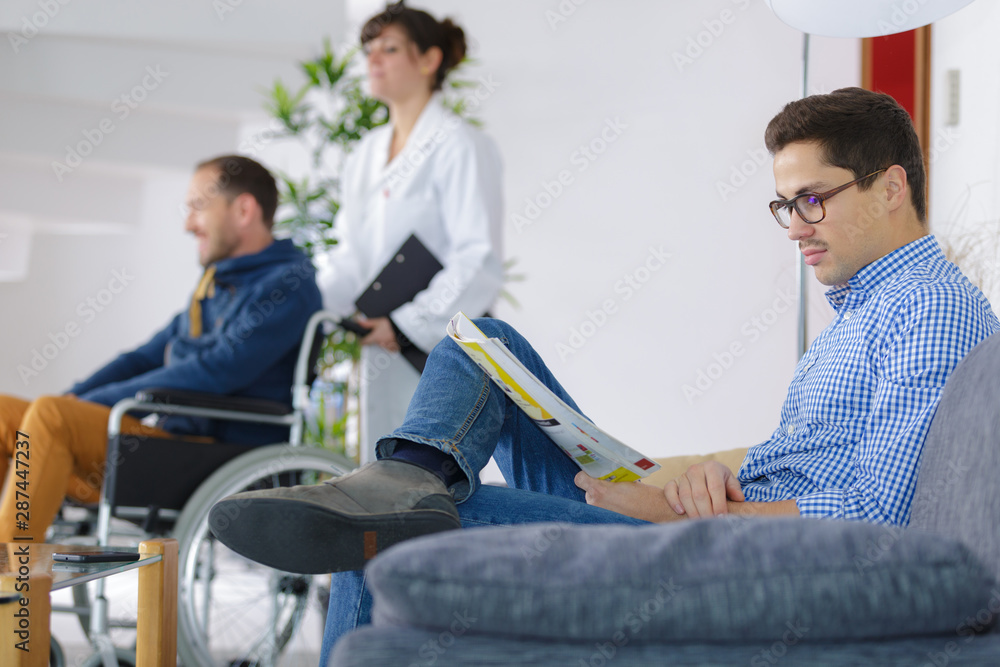 doctors at hospital reception while people sitting doctors at hospital reception while people sitting