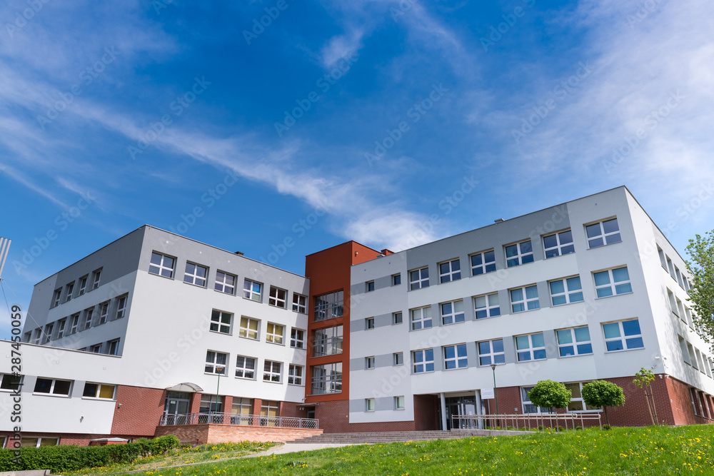 Public school building at sunny day, exterior view