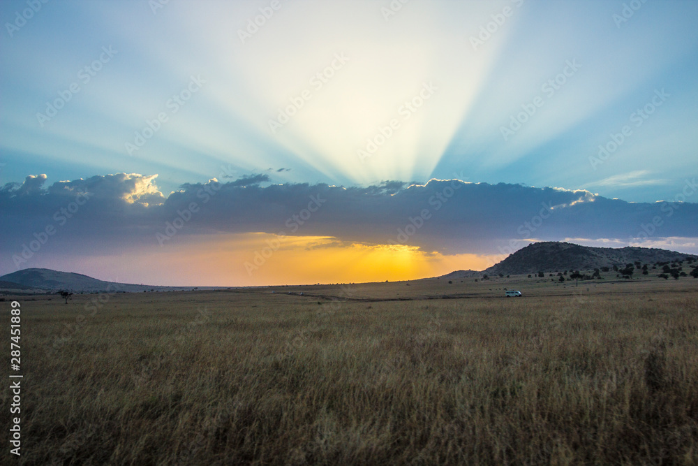 Sunset between the clouds in the Masai Mara. Kenya