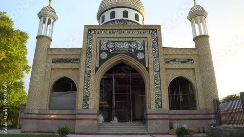 Istaravshan Sary Mazar Complex Mosque Under Construction Frontal View at Sunset on a Sunny Blue Sky Day photo