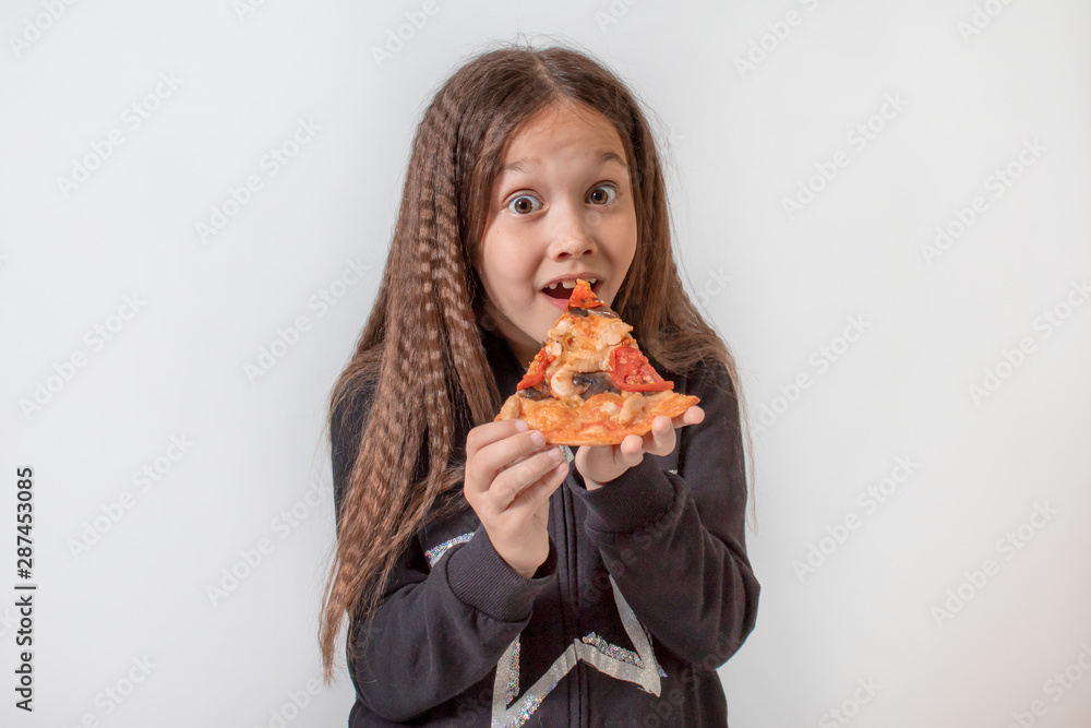 Little girl eating pizza. Baby puts pizza in her mouth Little girl eating pizza. Baby puts pizza in her mouth