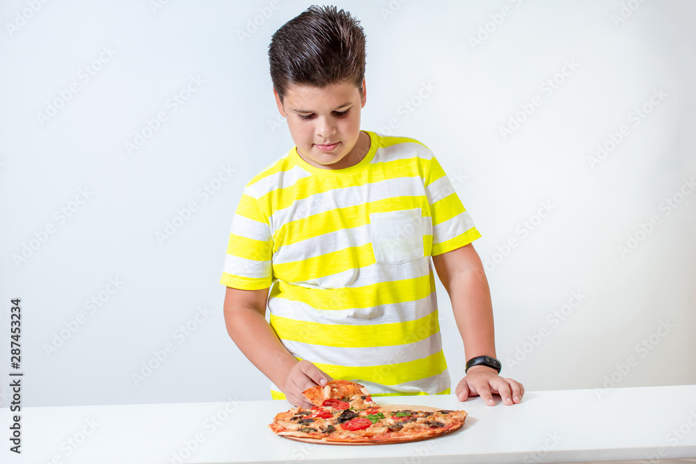 Little boy eating pizza. Happy child dines Little boy eating pizza. Happy child dines