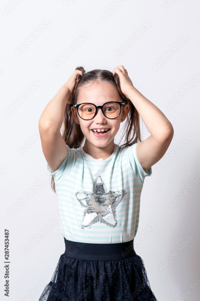 The little girl is happy. Child holding his head The little girl is happy. Child holding his head
