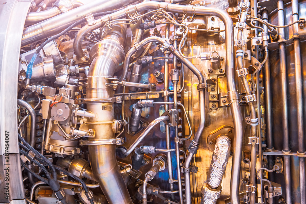 The complex mechanism of tubes and other binder systems in an airplane jet engine, close-up view. Industrial Production Theme.