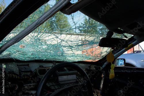 close-up of a completely broken car windshield view from the passenger compartment