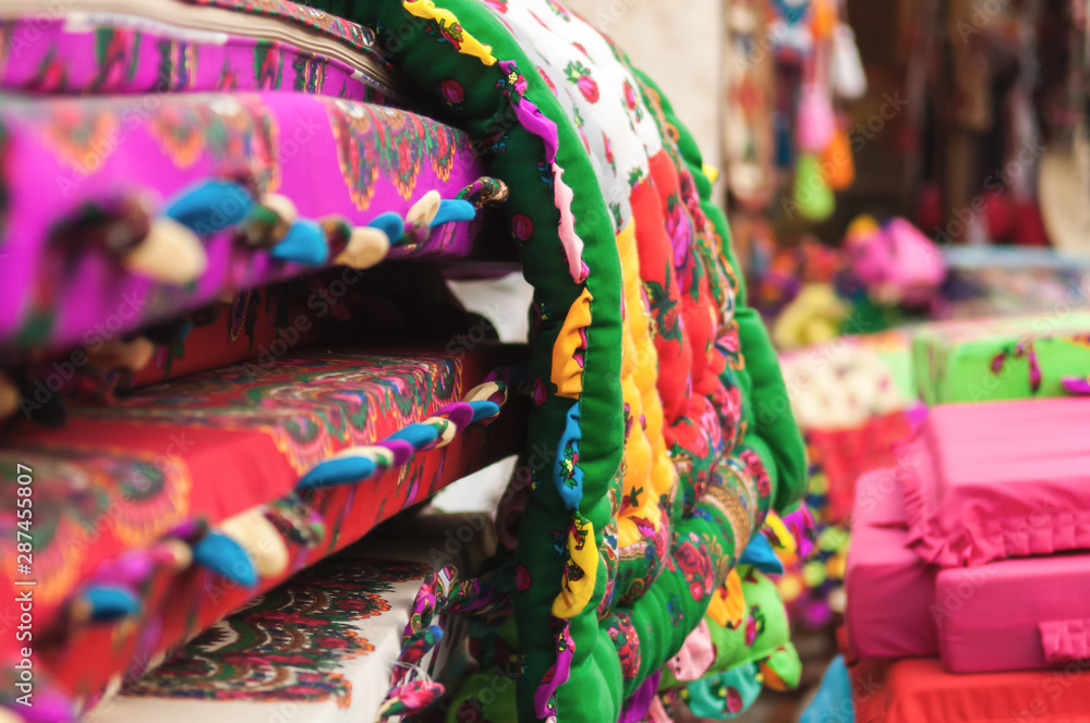 Selective focus on colorful mattress or rug used in Arabic and Asian culture. Taken at shop in Doha in Qatar.