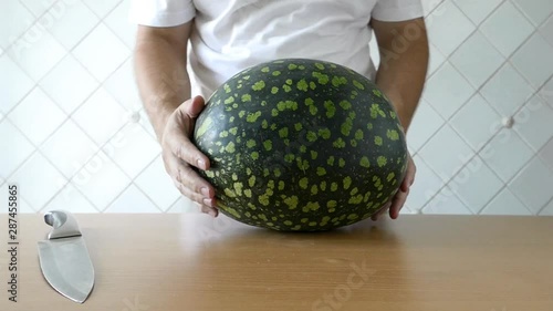 The man prepares watermelon. All clip. Different angles (foreshortening).