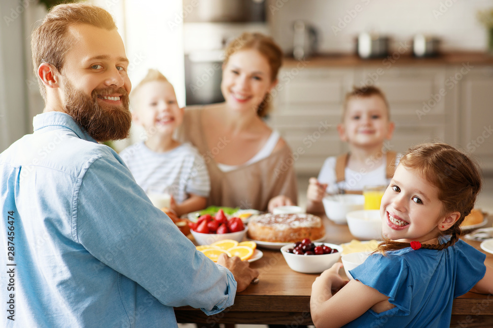 family mother father and children have Breakfast in kitchen in morning.