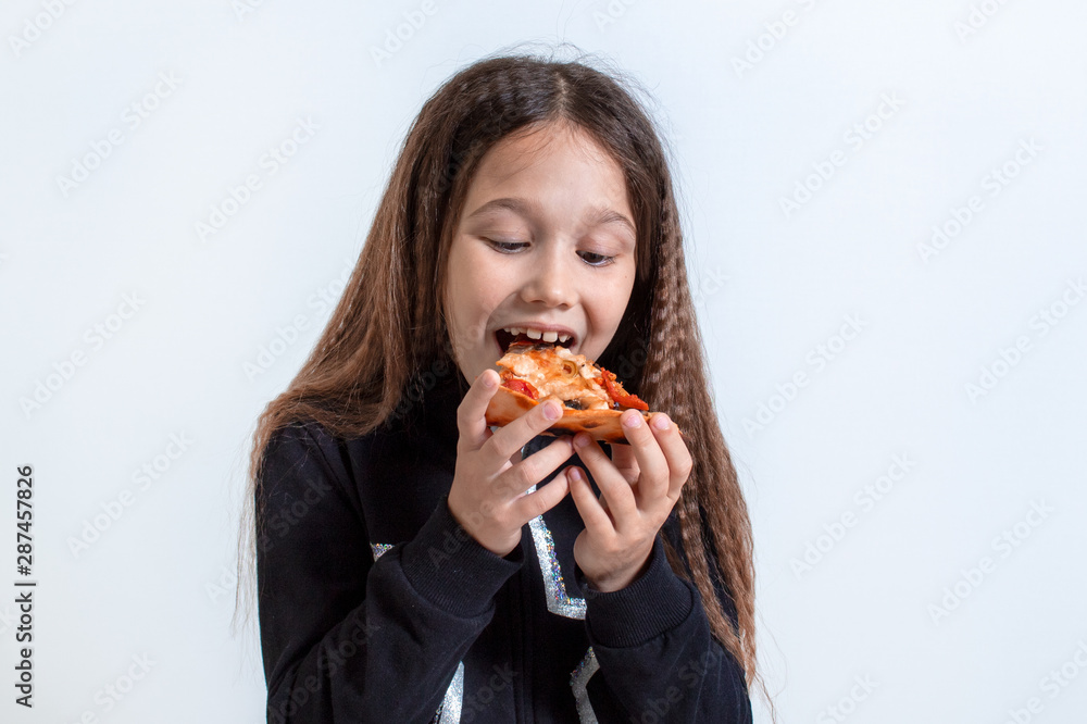 Little girl eating pizza. Baby puts pizza in her mouth Little girl eating pizza. Baby puts pizza in her mouth