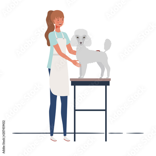 young woman combing a dog in pet groomer