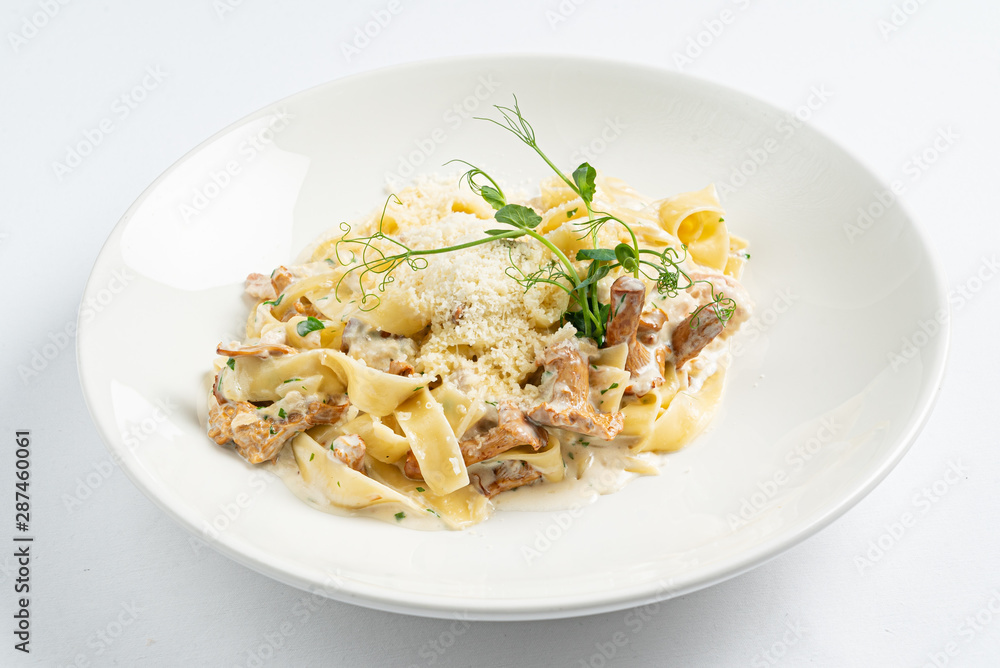 pasta with chanterelles on white plate
