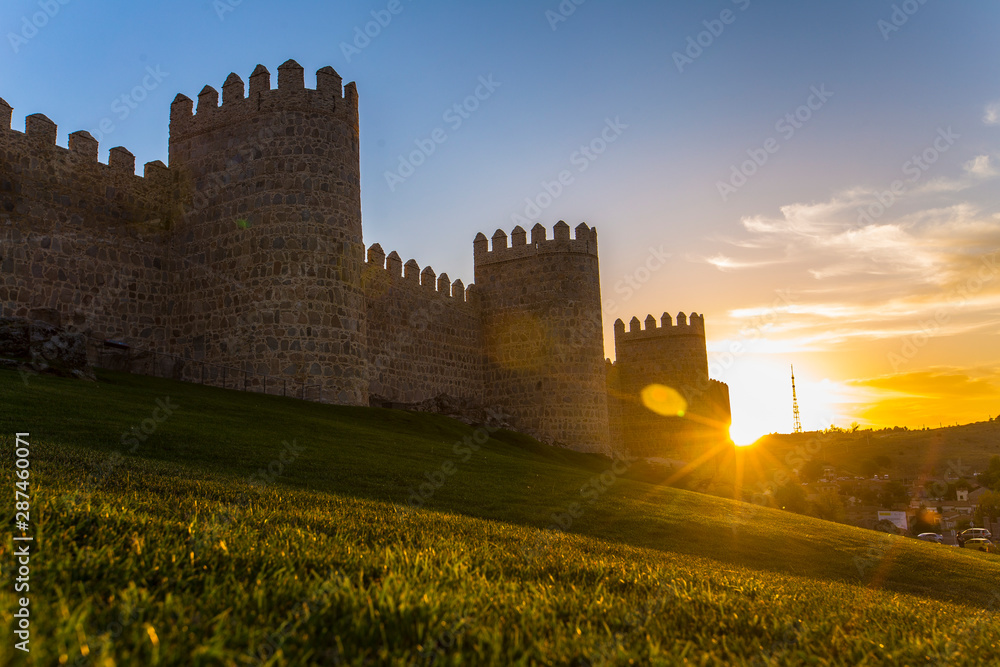The sun sets on the walls of Ávila in a beautiful sunset