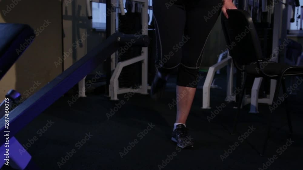 A woman of age performs a standing flexion of the leg.joint gymnastics.Copy space.close-up A woman of age performs a standing flexion of the leg.joint gymnastics.Copy space.close-up