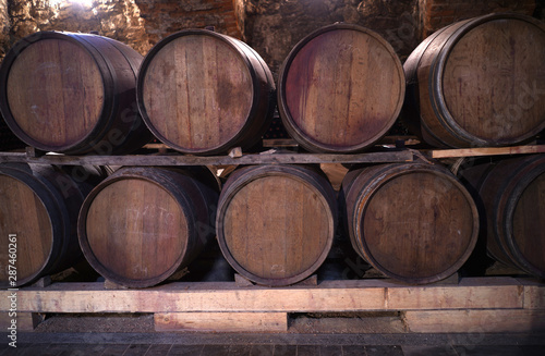 Vintage wine brown barrels with expensive tasty red wine. An old wine cellar in the center of Moldova © spoilergen