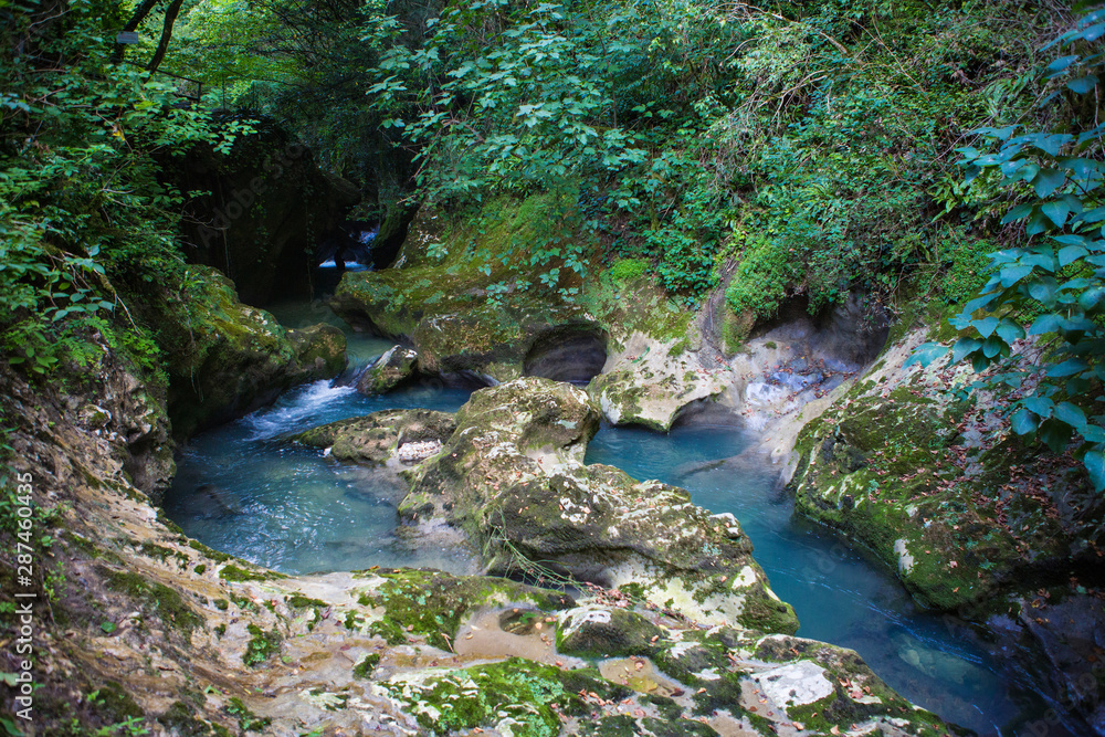 Naklejka premium blue mountain river with a waterfall