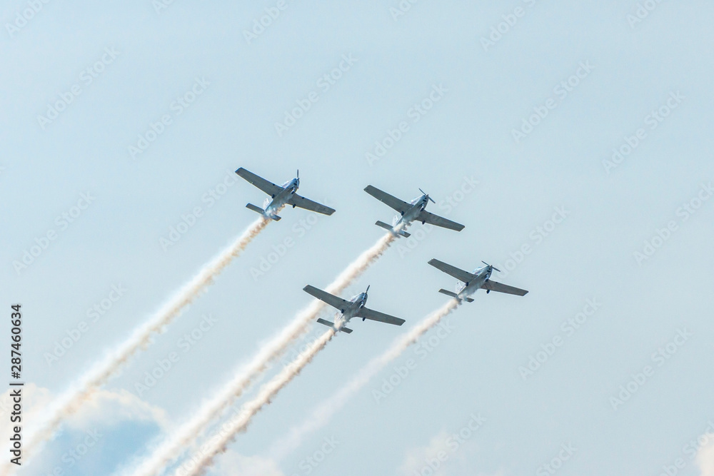 Airplanes on airshow. Aerobatic team performs flight at air show Airplanes on airshow. Aerobatic team performs flight at air show