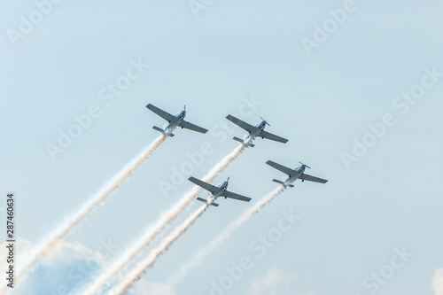 Airplanes on airshow. Aerobatic team performs flight at air show